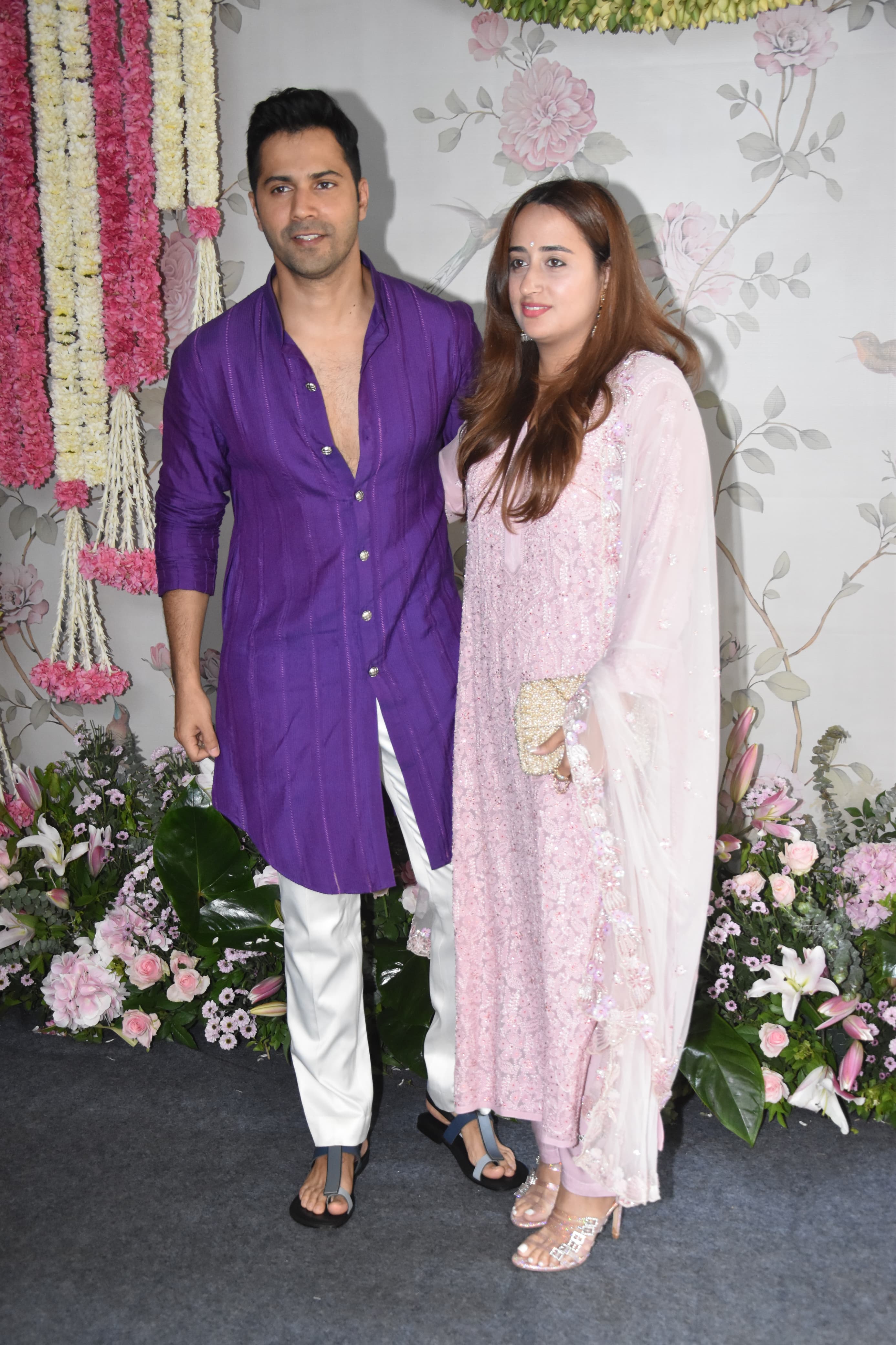  Varun Dhawan wore a vibrant purple kurta elegantly paired with white pajamas and Natasha Dalal, on the other hand, personified grace and sophistication in a pastel pink salwar set.